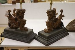 A pair of carved walnut winged griffin table lamps, 40cm high excl. light fitting