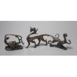 Three Chinese bronze figural brush rests, largest 15.5cm wide
