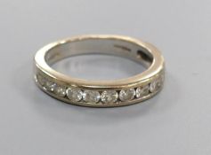 A diamond and 18ct white gold half eternity ring, size M, gross 4.5 grams.