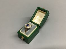 An 18ct, sapphire and diamond set oval cluster ring,size M, gross 2.8 grams.