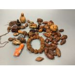 An assortment of Chinese peach stone and a nut carvings