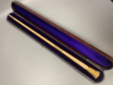A yellow metal mounted conductor's baton, with monogram to handle base, in fitted case