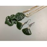 A Maori nephrite 'Hei-Tiki' pendant 6cm, on a 14k yellow metal flattened curb-link necklace 16.1.