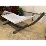 A weathered teak framed garden hammock, length 440cm, depth 130cm, height 120cm