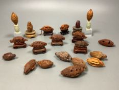 An assortment of Chinese peach stone and nut carvings