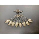 A set of eight late Victorian silver teaspoons, Sheffield, 1898 and a white metal child's rattle (