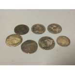 Six 18th century shillings and a sixpence and an Elizabeth I coin
