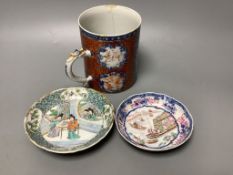 An 18th century Chinese export tankard and two 18th/19th century saucer dishes, tallest 13cm