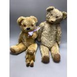 A vintage large plush jointed teddy bear with glass eyes and long muzzle, a later smaller jointed