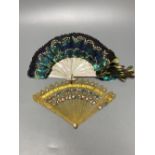 An early 20th century peacock? feather and mother of pearl fan and an early 19th century French