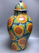 A large Mexican painted terracotta lidded baluster vase, decorated with stylised sunflowers,