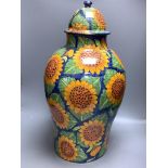 A large Mexican painted terracotta lidded baluster vase, decorated with stylised sunflowers,