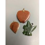 Two adventurine glass pendants, one a.f. and one other carved hardstone pendant.