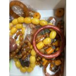 A quantity of assorted amber and faux amber necklaces.