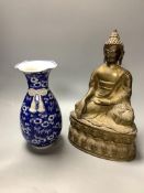 A bronze figure of a seated Buddha and a Japanese blue and white ovoid vase, of 'sack' form with