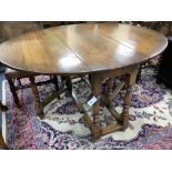 An 18th century style oval oak gateleg dining table, length 150cm extended, width 122cm, height