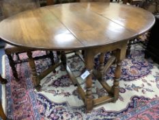 An 18th century style oval oak gateleg dining table, length 150cm extended, width 122cm, height