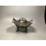 A late Victorian embossed silver fruit bowl, decorated with scrolls, baskets of fruit and masks,