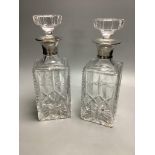 A pair of silver collared cut glass decanters, height 27cm
