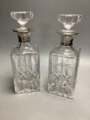 A pair of silver collared cut glass decanters, height 27cm