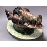 A Portuguese maiolica boar’s- head tureen, cover and stand, length 40cm