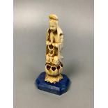 A 19th century Chinese carved ivory Guanyin, on a later lapis lazuli base, height 14cm