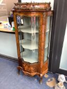 An early 20th century French gilt metal mounted rosewood vitrine, with central serpentine glazed