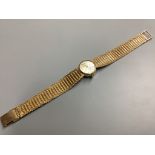 A lady's modern 9ct gold Avia manual wind wrist watch, on integral 9ct gold bracelet, overall 17.