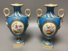 A pair of mid 19th century Coalport turquoise ground two handled vases, painted in Sévres style with
