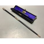 A George V silver mounted ebonised conductors baton in case, 45.3 cm.