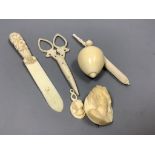 A group of early 19th/20th century ivory including a spinning top and a parasol needle case