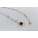 A 1920's white metal, hessonite garnet and diamond set drop pendant necklace, pendant 44mm,chain