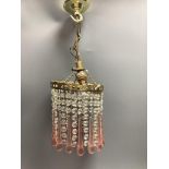 A ceiling pendant with clear and pink glass drops and a set of four French ormolu curtain tiebacks