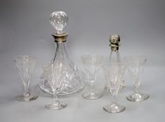 A silver collared cut glass decanter and a glass scent bottle with 800 standard silver stopper,