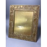 A Tiffany Studio's pierced gilt brass and mottled glass photograph frame, stamped to reverse '
