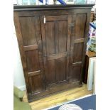 An 18th century and later panelled oak cabinet, width 130cm, depth 40cm, height 173cm