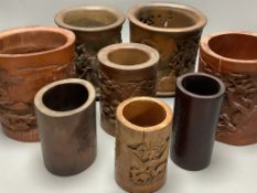An assortment of Chinese carved bamboo and wood brush pots, tallest 17cm (8)