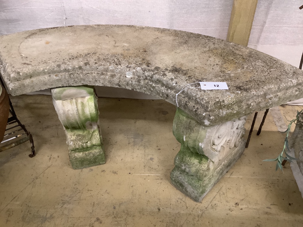 A reconstituted stone curved garden seat, length 110cm, depth 44cm, height 44cm