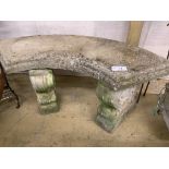 A reconstituted stone curved garden seat, length 110cm, depth 44cm, height 44cm