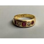 A late Victorian 18ct gold and gypsy set three stone ruby and two stone diamond half hoop ring,