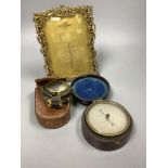 A pocket barometer, a compass, a 19th century desk stand and a photograph frame