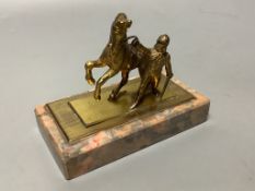 An early 20th century gilt metal group of a horse and jockey, on marble base, length 13cm