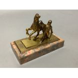 An early 20th century gilt metal group of a horse and jockey, on marble base, length 13cm