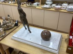 An Art Deco style bronze lady and a marble sphere, on marble base, length 76cm