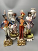 A pair of Italian porcelain figures of soldiers and a pair of Continental figural candlesticks