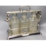 A late 19th / early 20th century silver plated three bottle tantalus, length 39cm