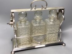 A late 19th / early 20th century silver plated three bottle tantalus, length 39cm