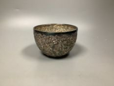 A late 19th/early 20th century Burmese embossed white metal bowl,diameter 13.5cm, 8oz.