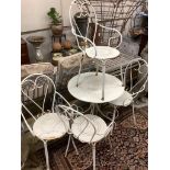 A wrought iron circular garden table, 70cm diameter, height 70cm and four chairs