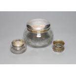 A 1920's silver mounted cut glass powder bowl, a similar small hair tidy and a silver napkin ring.